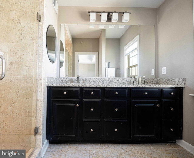 full bath with visible vents, a sink, a shower stall, and double vanity