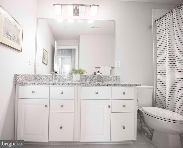 full bathroom featuring visible vents, double vanity, a sink, and toilet