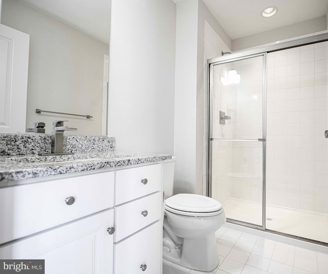 bathroom with a stall shower, tile patterned flooring, vanity, and toilet