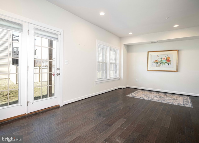 spare room featuring visible vents, baseboards, dark wood finished floors, and recessed lighting