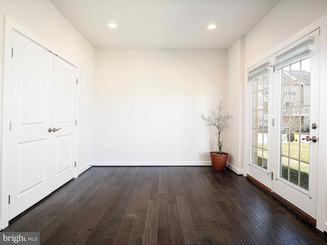 unfurnished bedroom featuring dark wood-type flooring, recessed lighting, access to outside, and baseboards