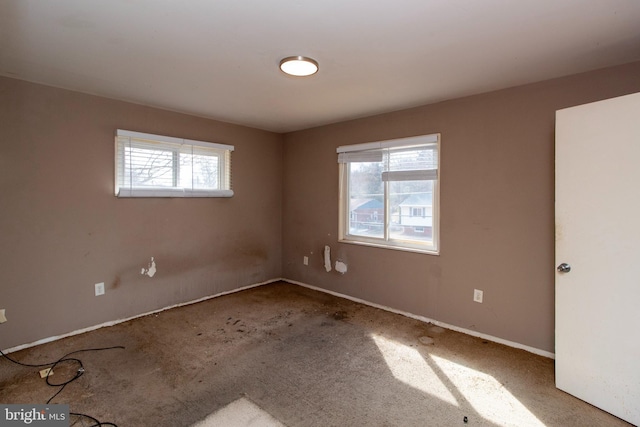 carpeted spare room with a healthy amount of sunlight