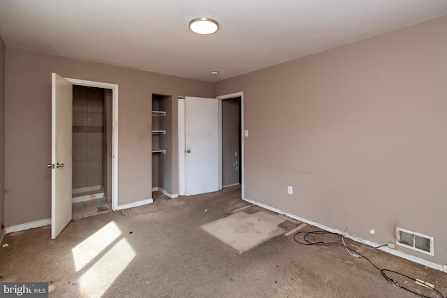 unfurnished bedroom with visible vents, carpet flooring, and baseboards