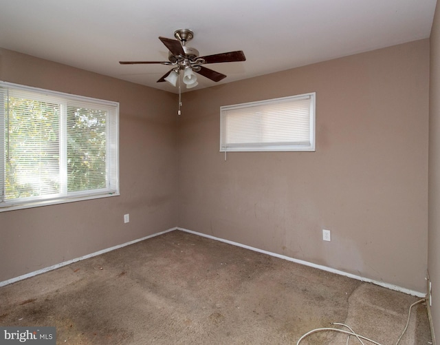 spare room with baseboards, carpet, and ceiling fan