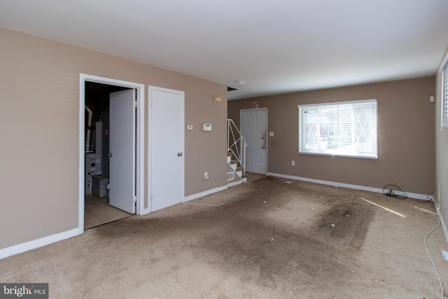 interior space with stairway and baseboards