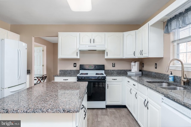 kitchen featuring white appliances, a sink, white cabinetry, and under cabinet range hood