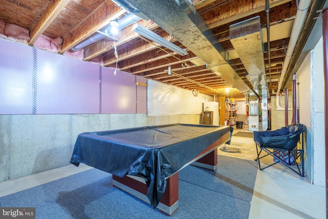 playroom featuring heating unit and concrete flooring