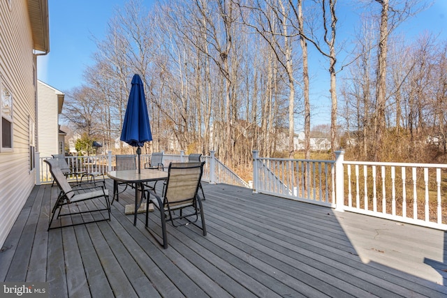 wooden terrace featuring outdoor dining space