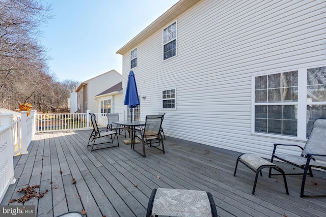 wooden terrace featuring outdoor dining area