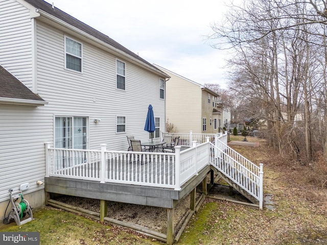 rear view of property featuring a deck