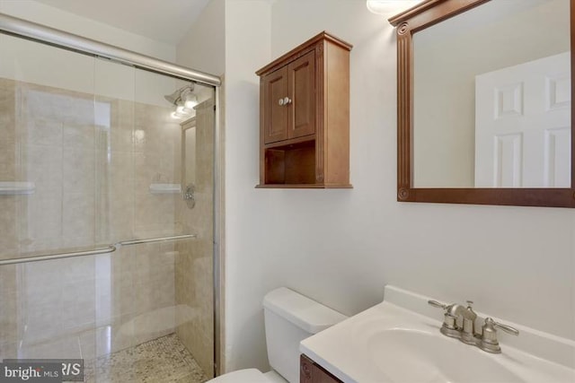 full bath with toilet, a stall shower, and vanity