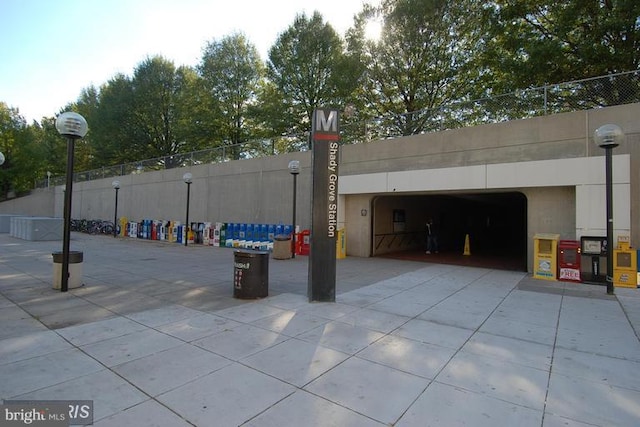 exterior space with an attached garage, driveway, and fence