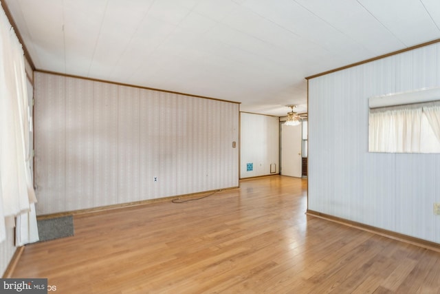 unfurnished room featuring ceiling fan, wood finished floors, and crown molding