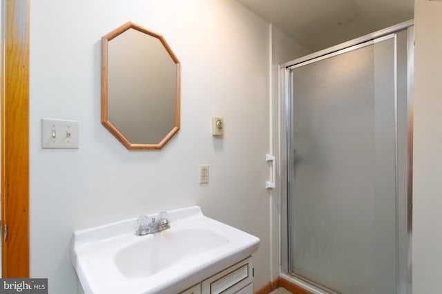 full bathroom with a shower stall and vanity