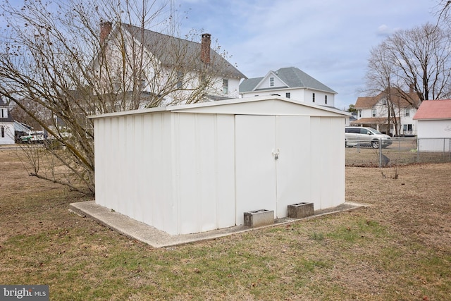 view of shed featuring fence