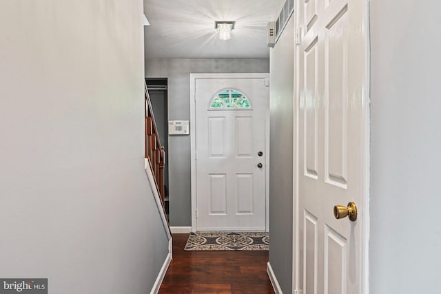 doorway to outside featuring stairs, baseboards, and dark wood-type flooring