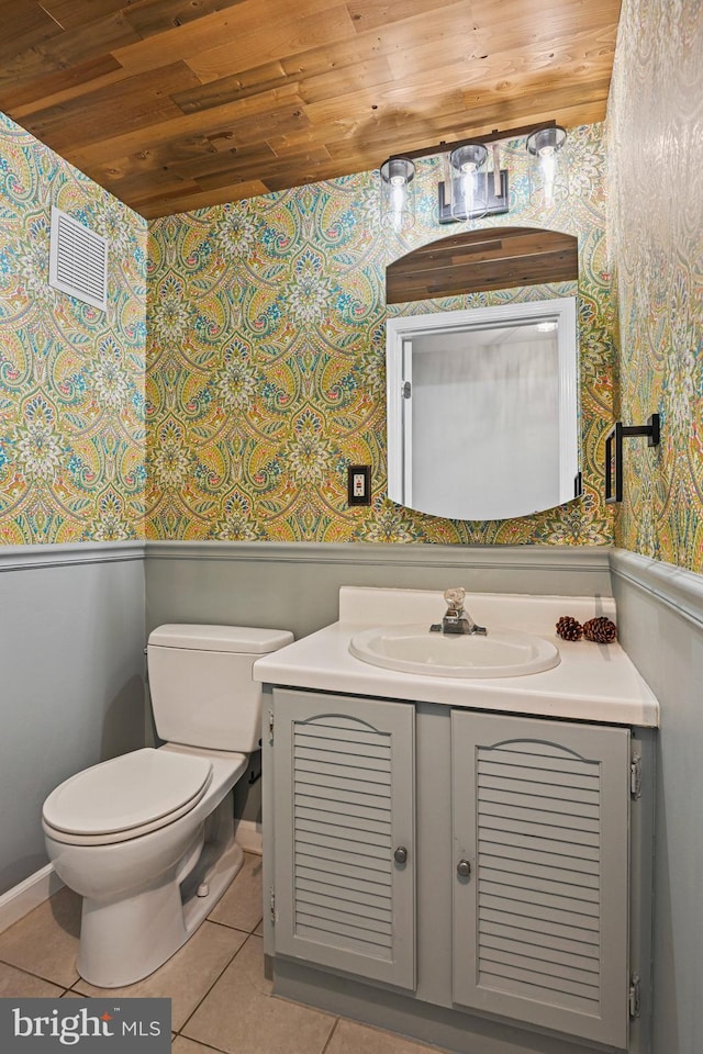 half bathroom with wooden ceiling, toilet, visible vents, vanity, and tile patterned floors