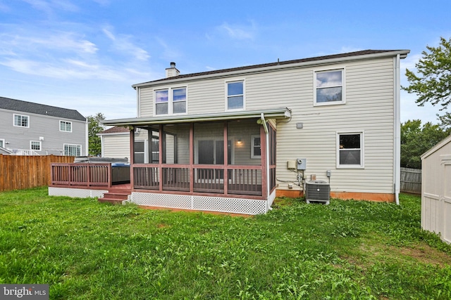 rear view of property featuring a yard, a chimney, fence, and central air condition unit