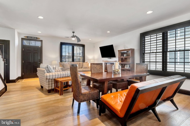 dining room with baseboards, light wood finished floors, and recessed lighting