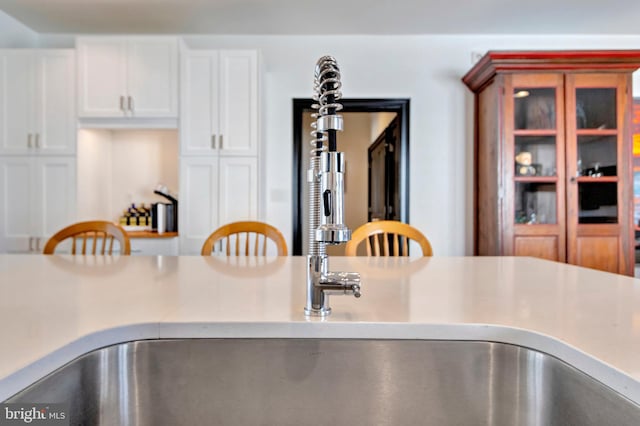 interior details with white cabinetry and light countertops