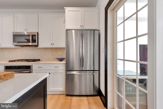 kitchen with light countertops, appliances with stainless steel finishes, and white cabinets