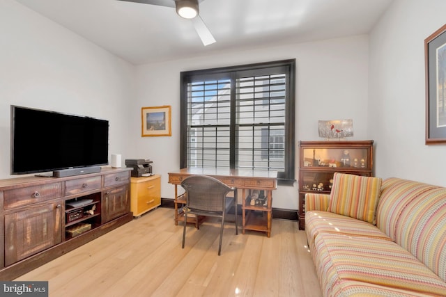 office with a ceiling fan, baseboards, and wood finished floors