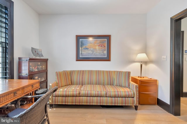 living room featuring wood finished floors and baseboards