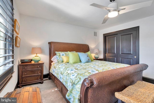 bedroom with carpet floors, ceiling fan, and visible vents