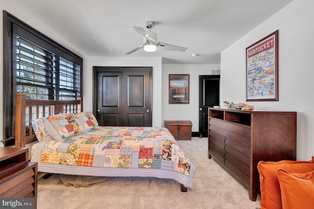 bedroom featuring ceiling fan and light colored carpet