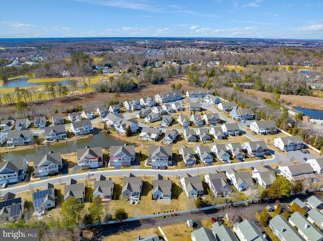 birds eye view of property featuring a residential view and a water view