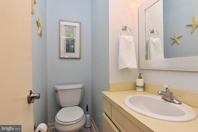 bathroom featuring toilet and vanity