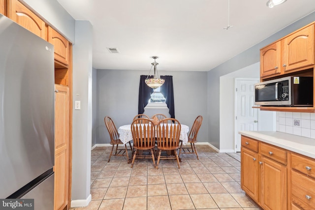 dining room with visible vents, baseboards, and light tile patterned floors