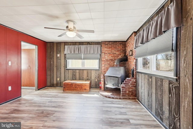 unfurnished room featuring a healthy amount of sunlight, ceiling fan, and wood finished floors