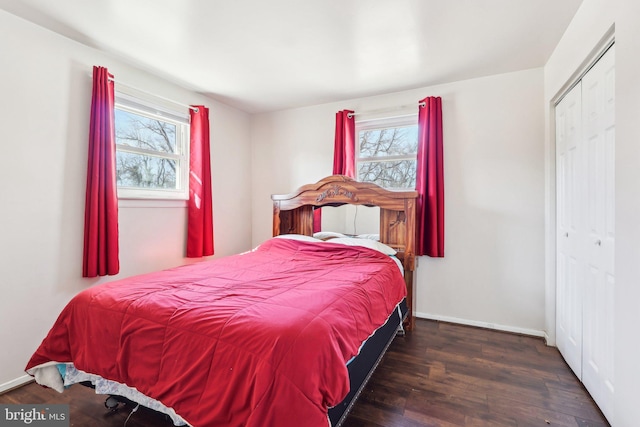 bedroom featuring a closet, wood finished floors, and baseboards