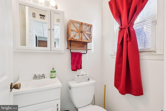 bathroom featuring toilet and vanity