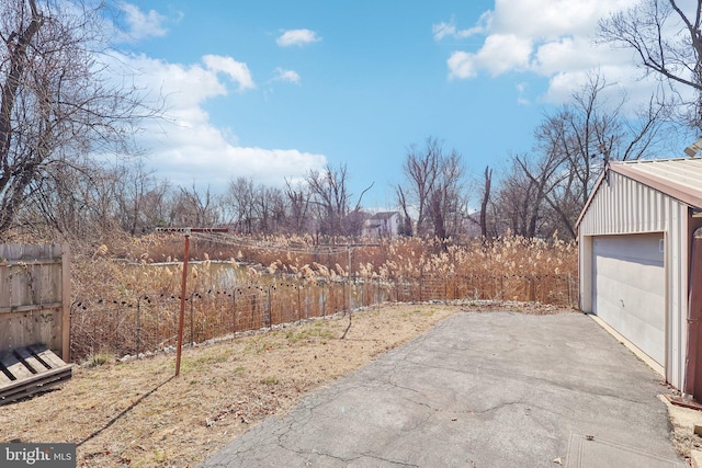 view of yard featuring fence and an outbuilding