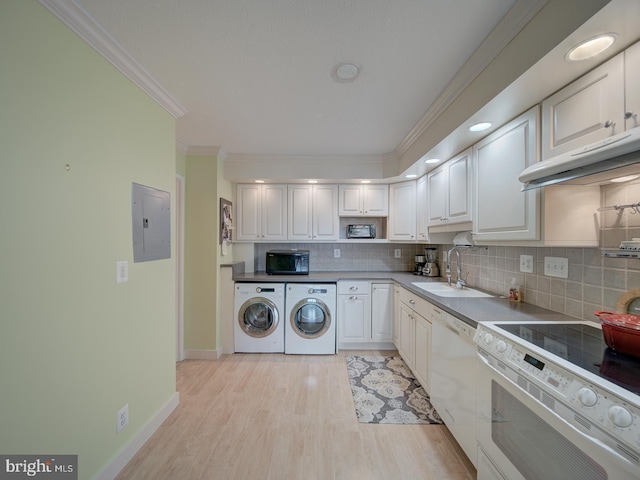 kitchen with white appliances, electric panel, crown molding, washer and dryer, and a sink