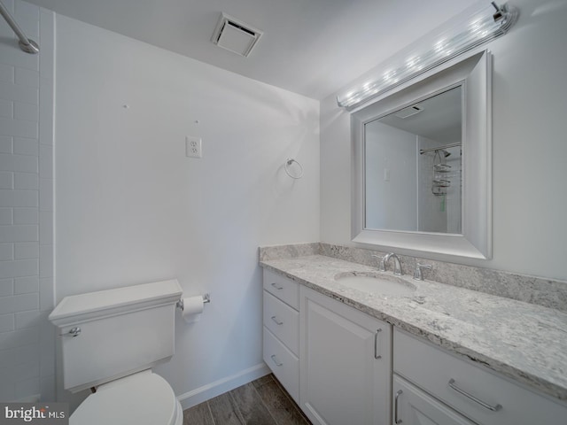 full bathroom with toilet, wood finished floors, vanity, visible vents, and a shower