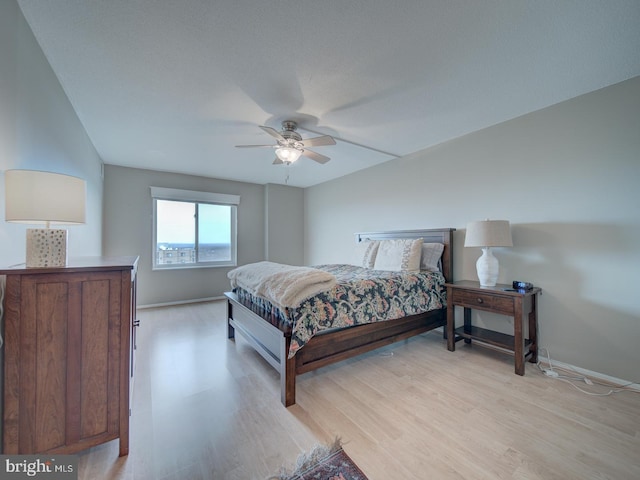 bedroom featuring light wood-style floors, ceiling fan, and baseboards