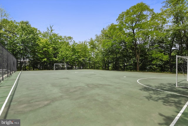 view of basketball court featuring fence