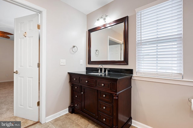 bathroom with tile patterned floors, vanity, and baseboards