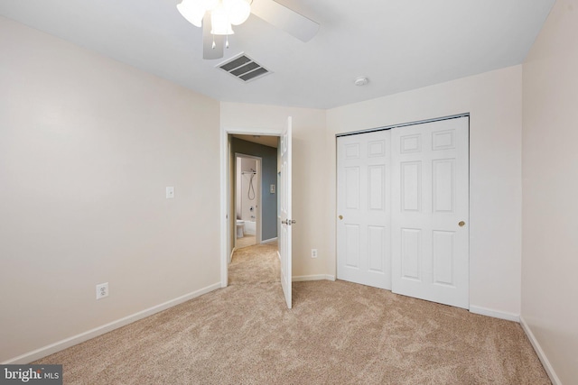 unfurnished bedroom with a closet, light colored carpet, visible vents, a ceiling fan, and baseboards