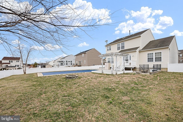 rear view of house featuring a yard, a patio area, and a fenced backyard