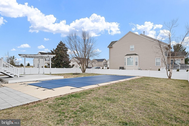 view of swimming pool featuring a fenced in pool, a lawn, a patio, fence, and a pergola