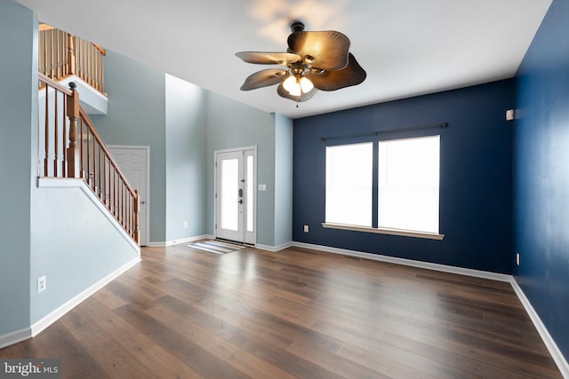 foyer entrance featuring baseboards, visible vents, a ceiling fan, stairway, and wood finished floors