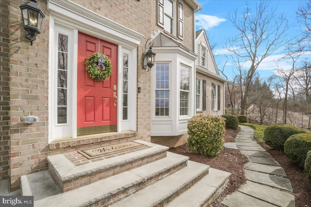 doorway to property with brick siding