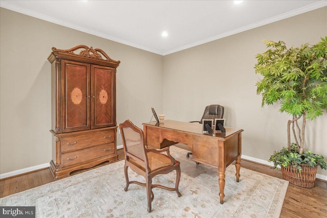 office space with light wood-style floors, baseboards, and crown molding