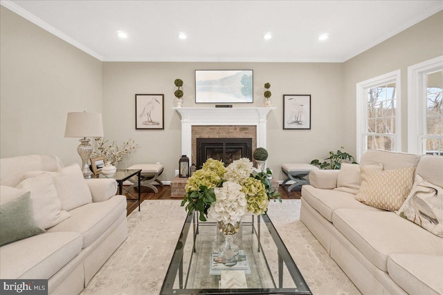 living area with ornamental molding, recessed lighting, a fireplace, and wood finished floors