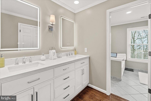 full bathroom with a sink and crown molding