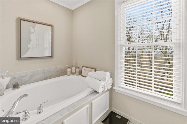 bathroom with a healthy amount of sunlight, baseboards, a bath, and ornamental molding